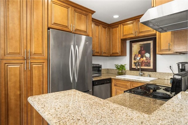 134 S Magnolia Ave Unit 21A, Anaheim, CA 92804 - kitchen featuring brown cabinetry, under cabinet range hood, light stone counters, a sink, and appliances with stainless steel finishes