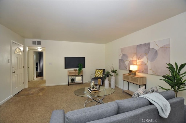 carpeted living area with visible vents and baseboards