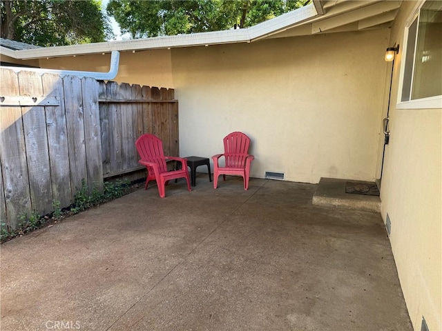 view of patio featuring fence and visible vents