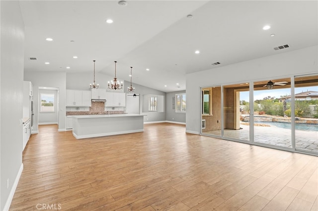 unfurnished living room featuring recessed lighting, baseboards, light wood-type flooring, and visible vents