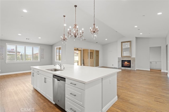 30404 Canyon Point Cir, Menifee, CA 92584 - kitchen featuring stainless steel dishwasher, vaulted ceiling, open floor plan, a chandelier, and a kitchen island with sink