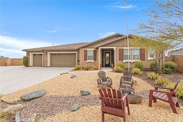 30404 Canyon Point Cir, Menifee, CA 92584 - single story home with an outdoor fire pit, driveway, a garage, and stucco siding