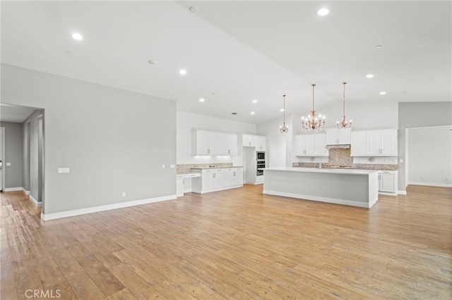 30404 Canyon Point Cir, Menifee, CA 92584 - unfurnished living room featuring a chandelier, light wood-style floors, recessed lighting, and high vaulted ceiling