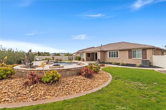 rear view of property with fence, cooling unit, a fire pit, and a patio area