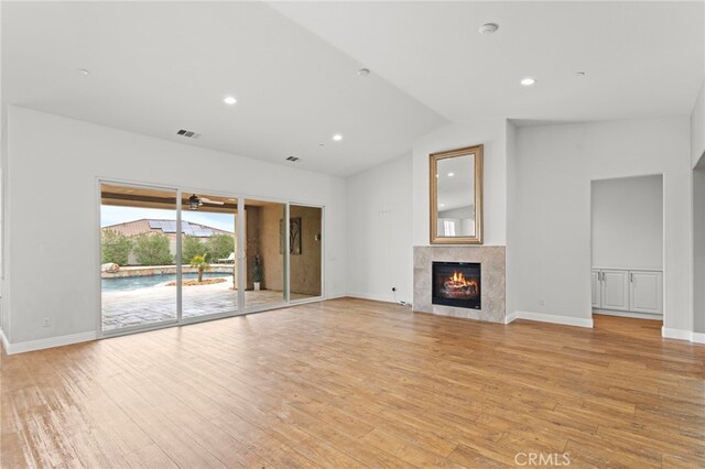 30404 Canyon Point Cir, Menifee, CA 92584 - unfurnished living room with a premium fireplace, vaulted ceiling, light wood-style floors, recessed lighting, and a ceiling fan