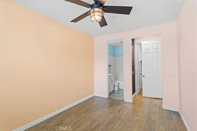 30404 Canyon Point Cir, Menifee, CA 92584 - unfurnished bedroom featuring wood-type flooring, ensuite bathroom, and a ceiling fan