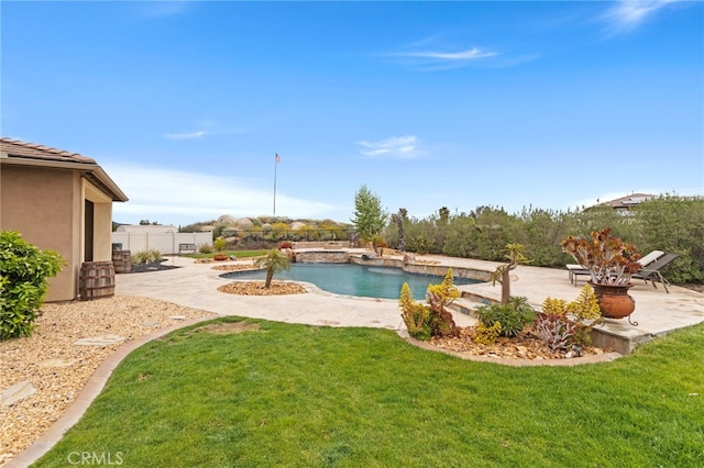 outdoor pool with a yard, fence, and a patio area