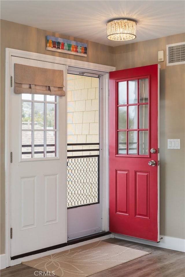 26872 Vista Del Mar, Dana Point, CA 92624 - doorway featuring visible vents, baseboards, and wood finished floors