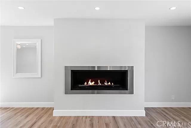 26872 Vista Del Mar, Dana Point, CA 92624 - details featuring baseboards, recessed lighting, wood finished floors, and a lit fireplace