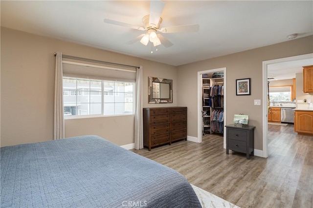 26872 Vista Del Mar, Dana Point, CA 92624 - bedroom featuring a walk in closet, ceiling fan, baseboards, a closet, and light wood-style flooring
