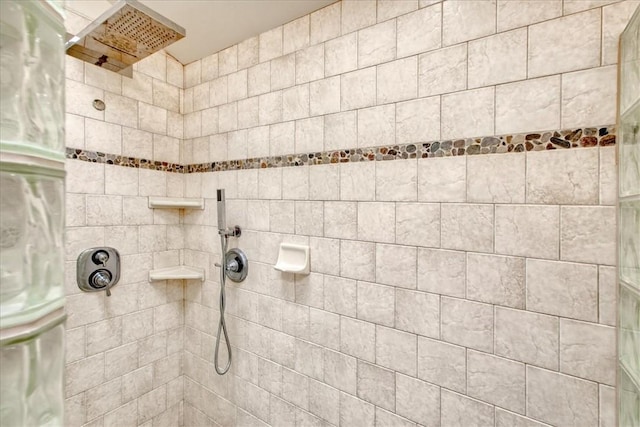interior details featuring a tile shower