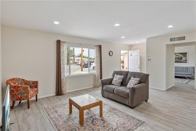 living area featuring visible vents, recessed lighting, light wood-style floors, and baseboards