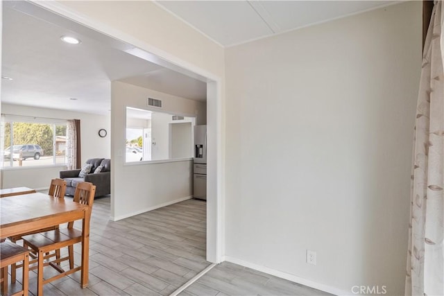 dining room with visible vents, baseboards, and wood finished floors