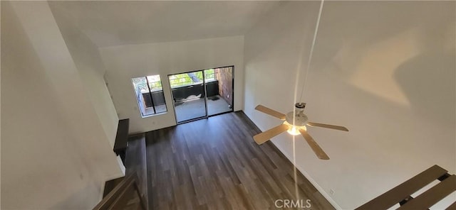 unfurnished living room with dark wood finished floors and ceiling fan