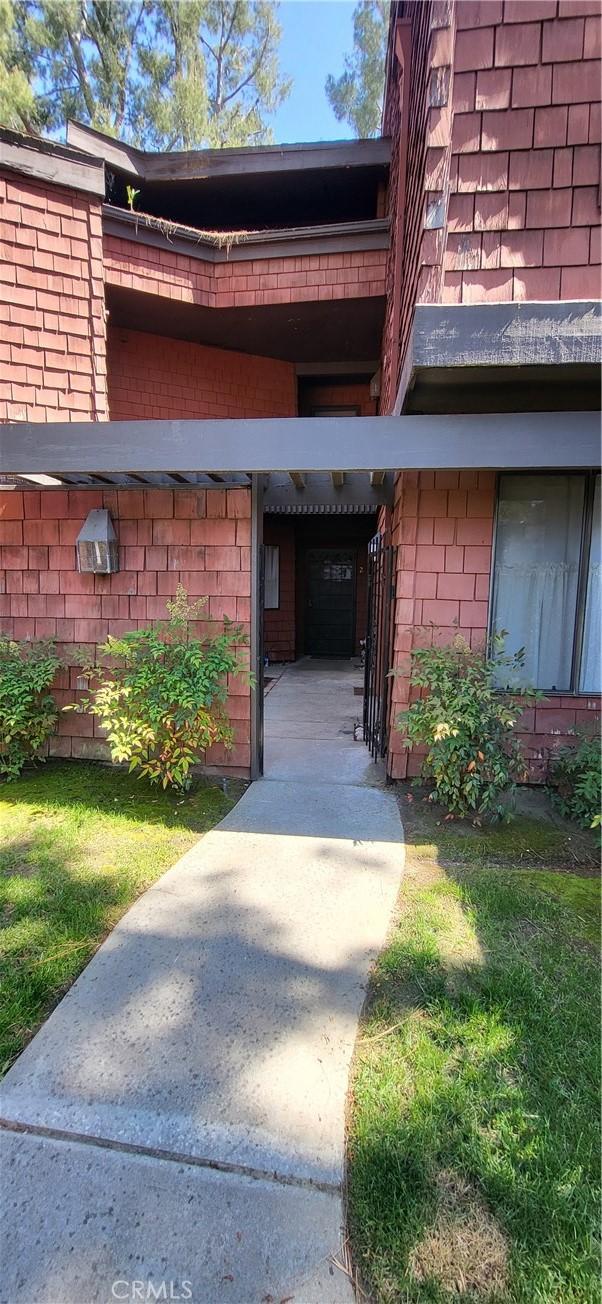 view of exterior entry with brick siding