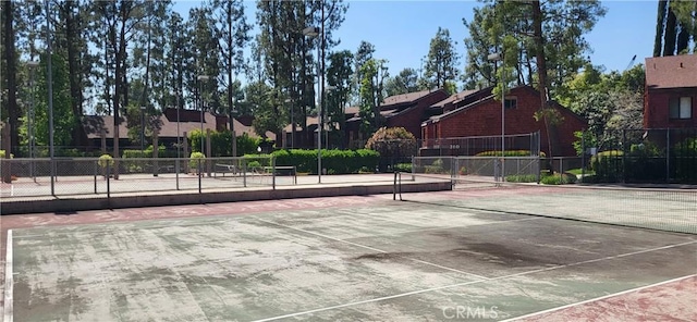 view of tennis court with fence