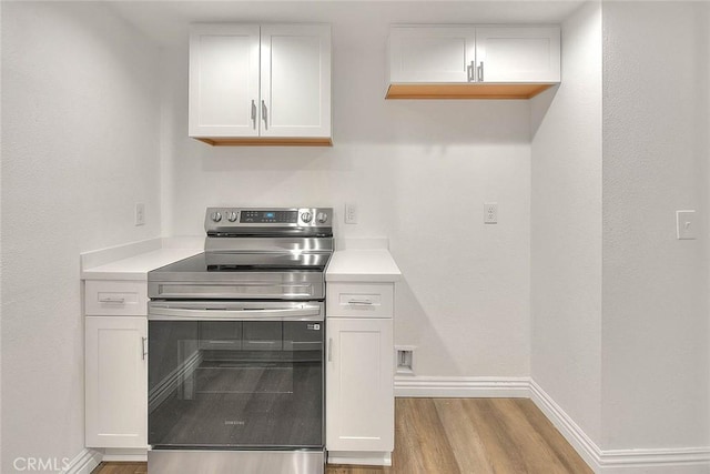 348 S Prospectors Rd Unit 8, Diamond Bar, CA 91765 - kitchen with stainless steel range with electric cooktop, wood finished floors, baseboards, white cabinetry, and light countertops