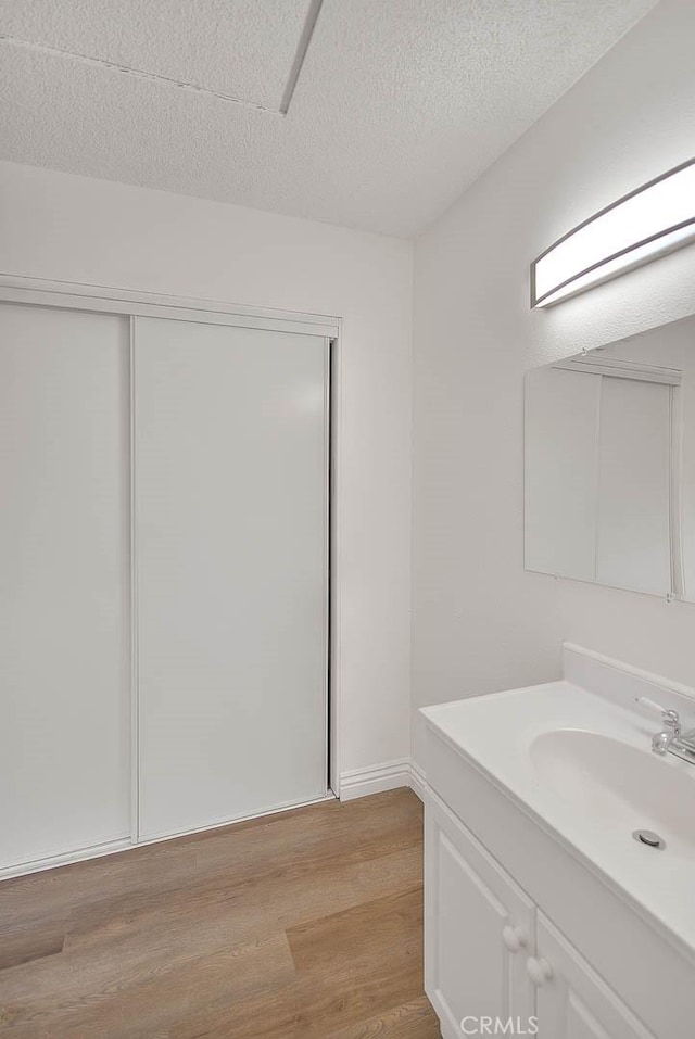 348 S Prospectors Rd Unit 8, Diamond Bar, CA 91765 - bathroom with wood finished floors, vanity, and a textured ceiling