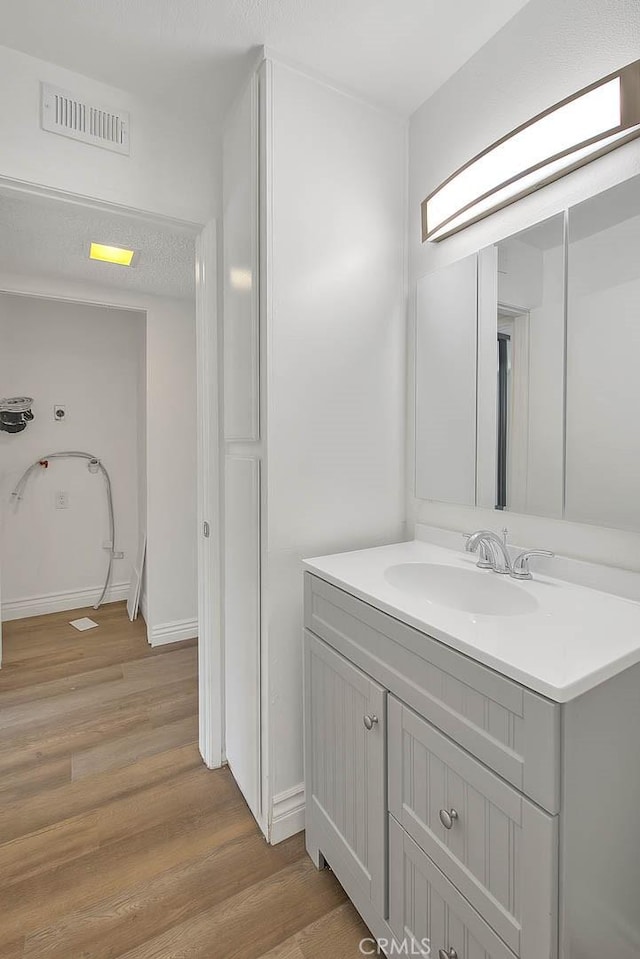 348 S Prospectors Rd Unit 8, Diamond Bar, CA 91765 - bathroom featuring wood finished floors, vanity, and baseboards