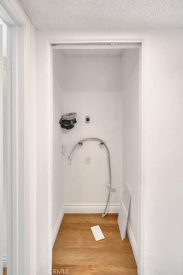 348 S Prospectors Rd Unit 8, Diamond Bar, CA 91765 - clothes washing area featuring light wood-style flooring, a textured ceiling, and baseboards