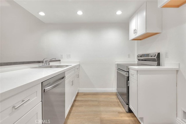 348 S Prospectors Rd Unit 8, Diamond Bar, CA 91765 - kitchen featuring stainless steel appliances, a sink, light wood-style flooring, white cabinets, and light countertops