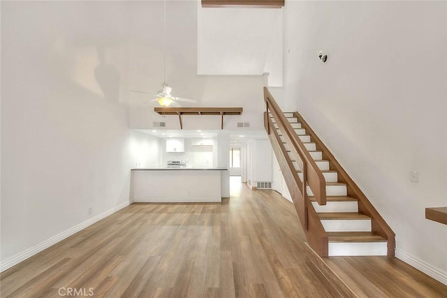 348 S Prospectors Rd Unit 8, Diamond Bar, CA 91765 - stairway with a high ceiling, wood finished floors, a ceiling fan, and baseboards