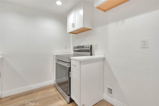 348 S Prospectors Rd Unit 8, Diamond Bar, CA 91765 - kitchen featuring electric stove, light countertops, light wood-style floors, white cabinets, and baseboards