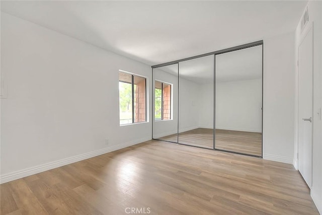 348 S Prospectors Rd Unit 8, Diamond Bar, CA 91765 - unfurnished bedroom featuring wood finished floors, baseboards, and a closet
