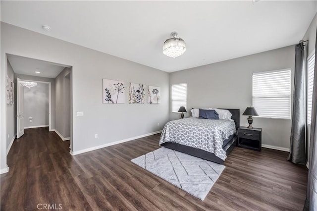 bedroom with baseboards and wood finished floors