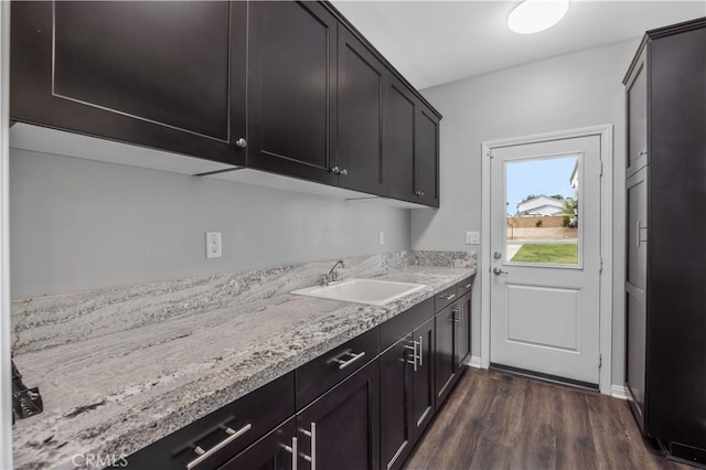 laundry room with a sink and dark wood-style floors