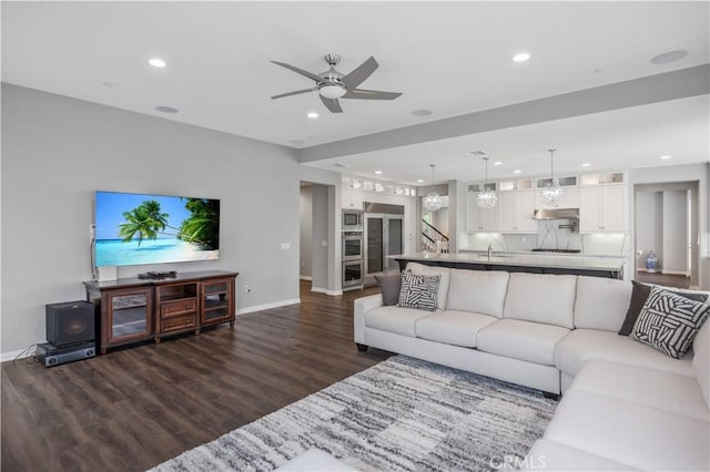 living area featuring recessed lighting, baseboards, a ceiling fan, and dark wood-style floors