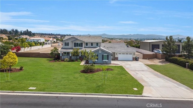 view of front of house featuring a garage, fence, concrete driveway, and a front yard