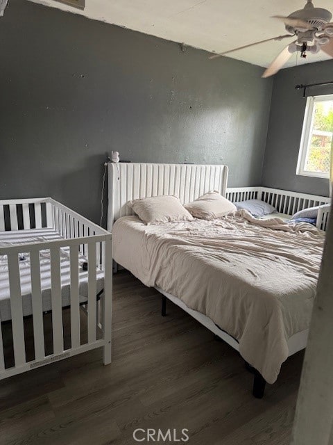 bedroom featuring a ceiling fan and wood finished floors