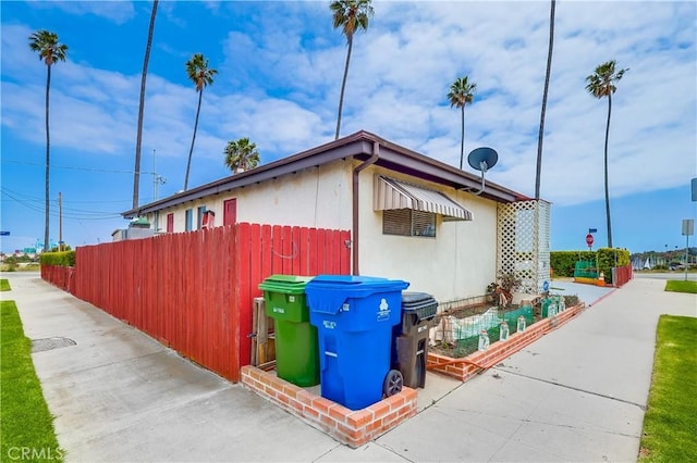 view of side of home with fence