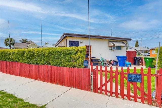 view of front of home with fence and stucco siding