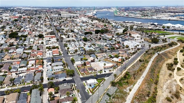 drone / aerial view featuring a residential view and a water view