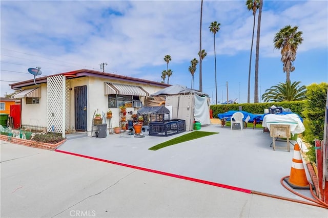 exterior space with a patio and stucco siding