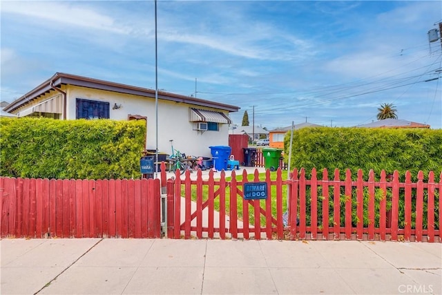 exterior space with a fenced front yard and stucco siding