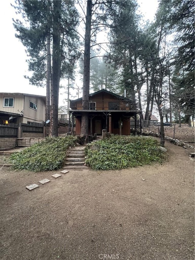back of house featuring fence
