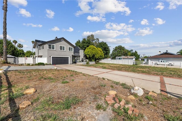 15064 Marcolesco St, Lake Elsinore, CA 92530 - exterior space featuring concrete driveway, stucco siding, fence, and a garage