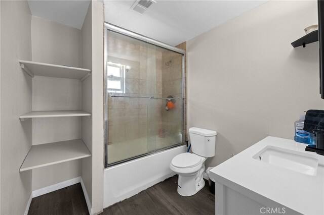 15064 Marcolesco St, Lake Elsinore, CA 92530 - bathroom featuring enclosed tub / shower combo, toilet, wood finished floors, and visible vents