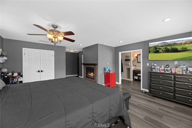 15064 Marcolesco St, Lake Elsinore, CA 92530 - bedroom with ceiling fan, a fireplace, recessed lighting, baseboards, and wood finished floors
