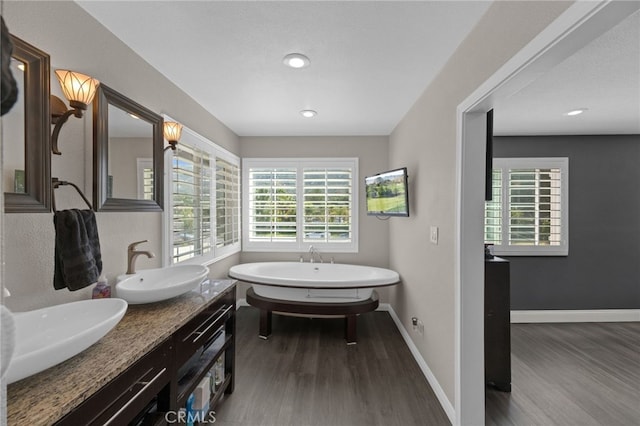 15064 Marcolesco St, Lake Elsinore, CA 92530 - full bath featuring plenty of natural light, a sink, wood finished floors, and a soaking tub