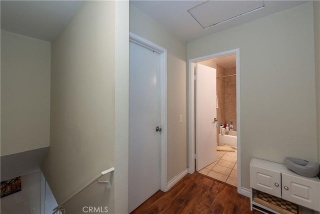hall with dark wood-type flooring and attic access