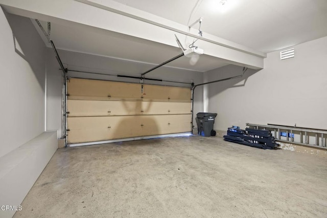 garage with visible vents and a garage door opener