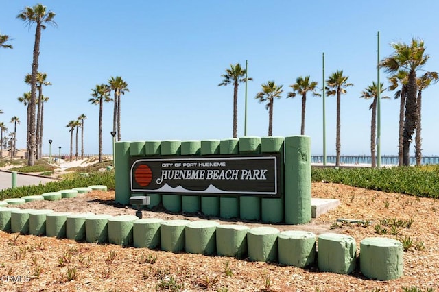 community / neighborhood sign featuring a water view
