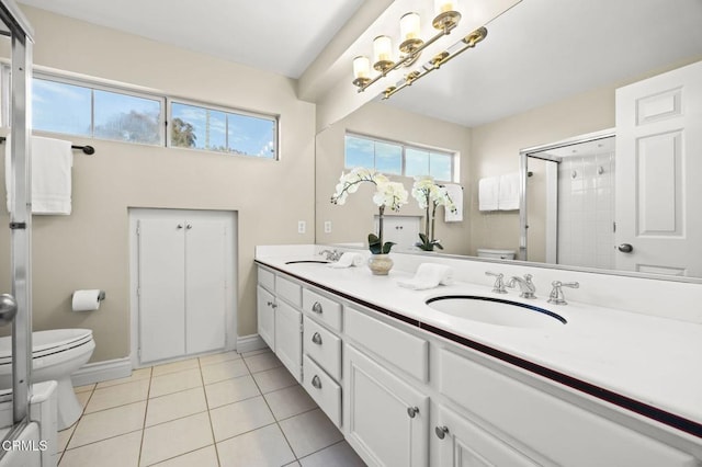 full bath with double vanity, tile patterned flooring, a shower stall, a sink, and toilet