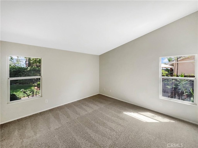 carpeted spare room with baseboards