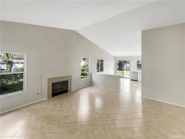 103 Buckthorn Way, Corona, CA 92881 - unfurnished living room featuring plenty of natural light, light tile patterned floors, a tile fireplace, lofted ceiling, and recessed lighting