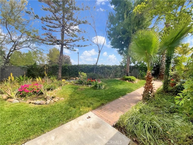 surrounding community featuring a lawn and fence